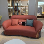 Curved Terracotta Leather Sofa and Blue Accent Chair Set with High-Gloss Wood Details